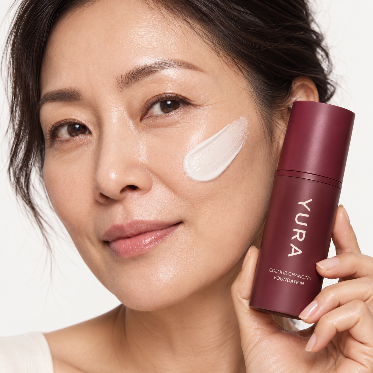 Woman holding YURA Korean colour-changing foundation